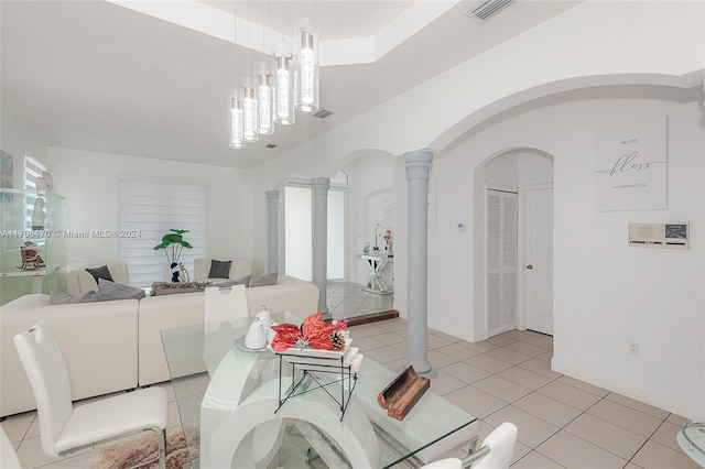 dining space featuring ornate columns, light tile patterned floors, and a notable chandelier