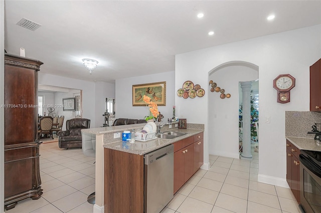 kitchen with light tile patterned flooring, appliances with stainless steel finishes, backsplash, and sink