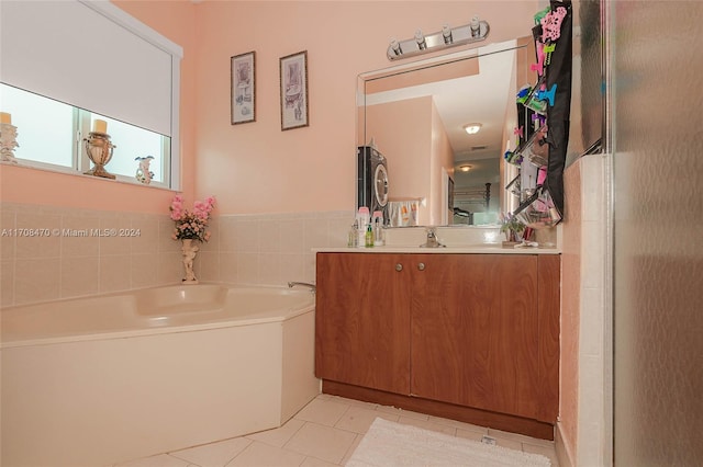 bathroom featuring tile patterned flooring, a bathtub, and vanity