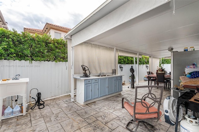 view of patio / terrace with area for grilling and sink