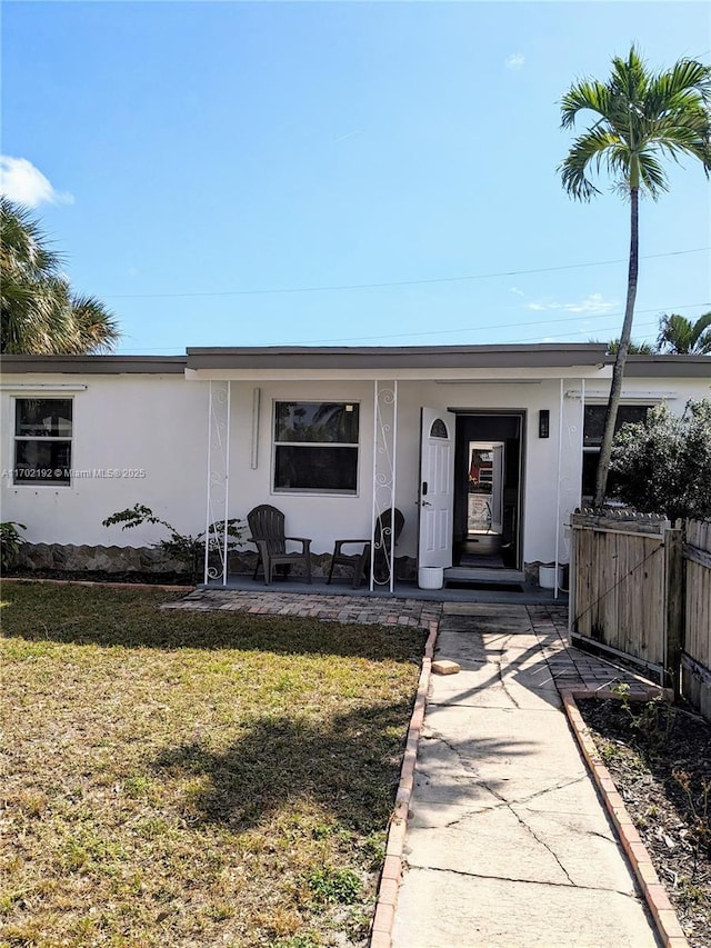 1916 NE 54th St, Pompano Beach, FL 33064 - view of front of home with a porch and stucco siding