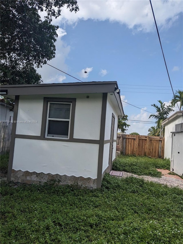 view of side of home with a yard