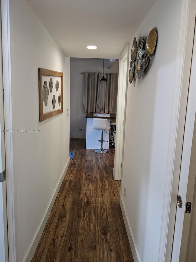 hallway with dark wood-type flooring