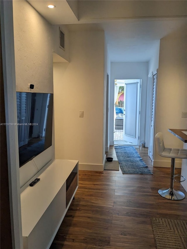 hallway featuring dark hardwood / wood-style flooring