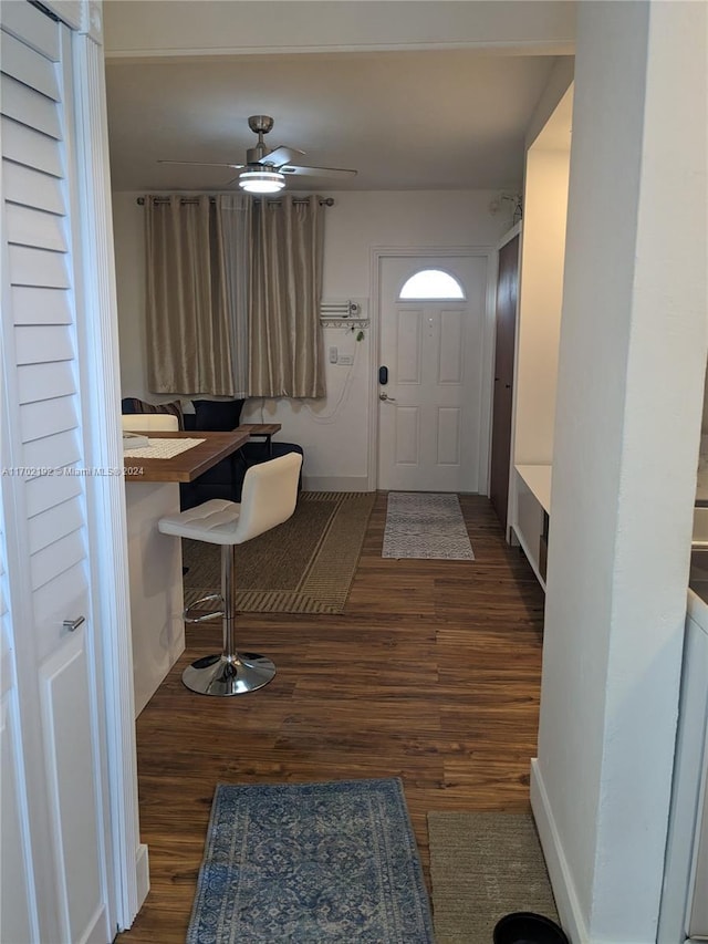 doorway to outside with dark hardwood / wood-style floors and ceiling fan