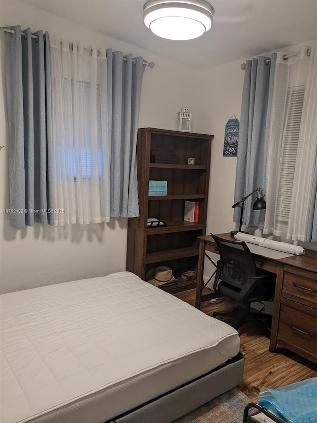bedroom featuring wood finished floors