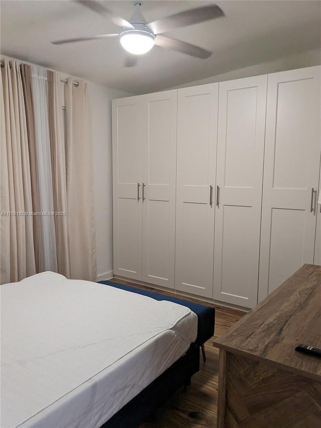 bedroom with dark wood-type flooring and ceiling fan