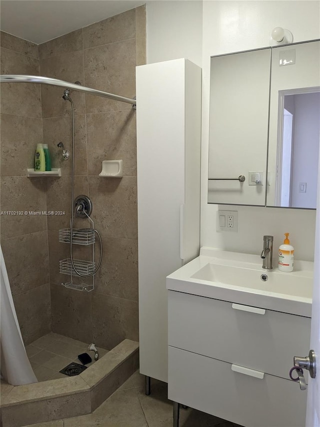 bathroom with tile patterned flooring, vanity, and curtained shower