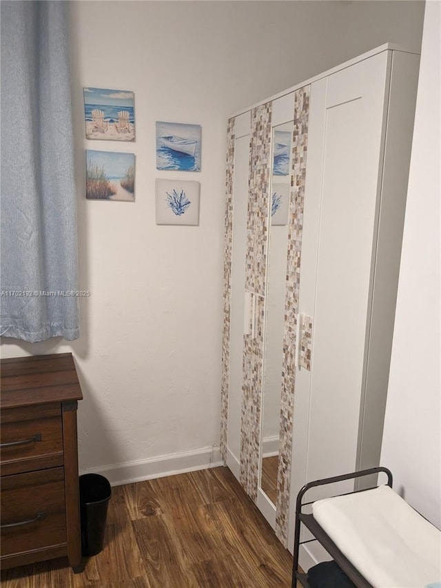 interior space with dark wood-type flooring and baseboards