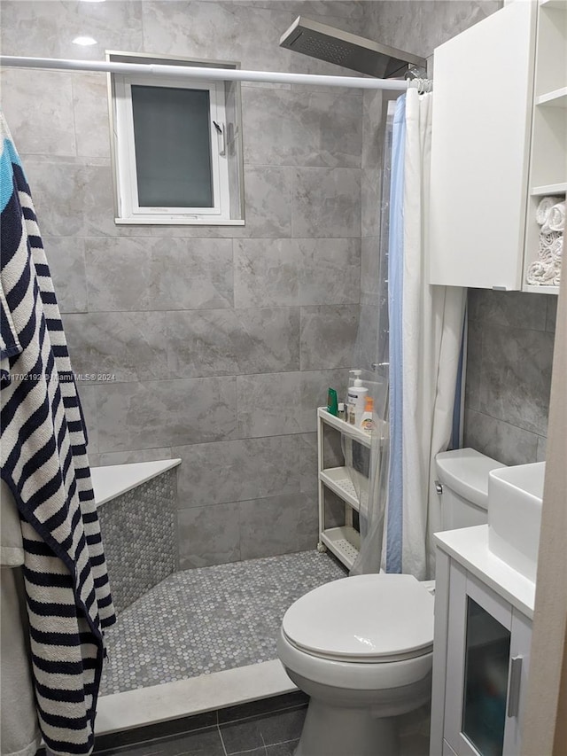 bathroom featuring a shower with shower curtain, tile patterned flooring, toilet, and vanity