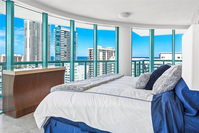 tiled bedroom with a water view and multiple windows