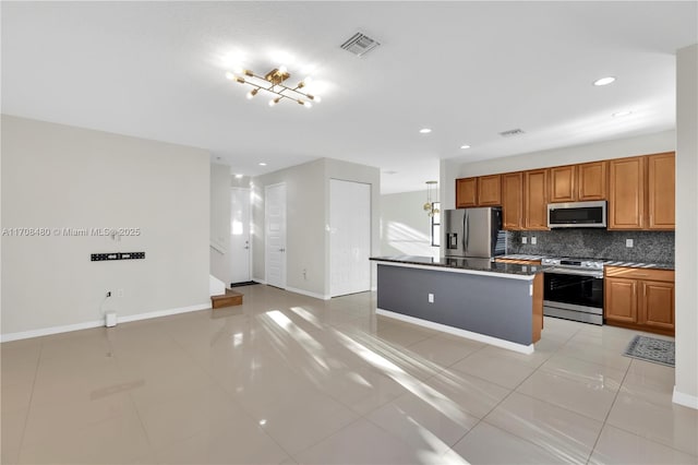 kitchen featuring baseboards, visible vents, decorative backsplash, stainless steel appliances, and light tile patterned flooring