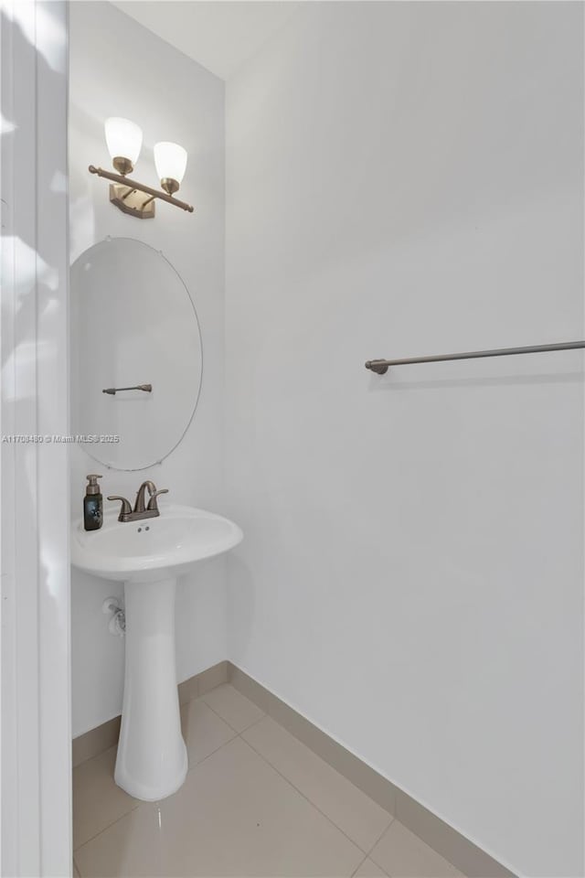 bathroom with tile patterned flooring and baseboards