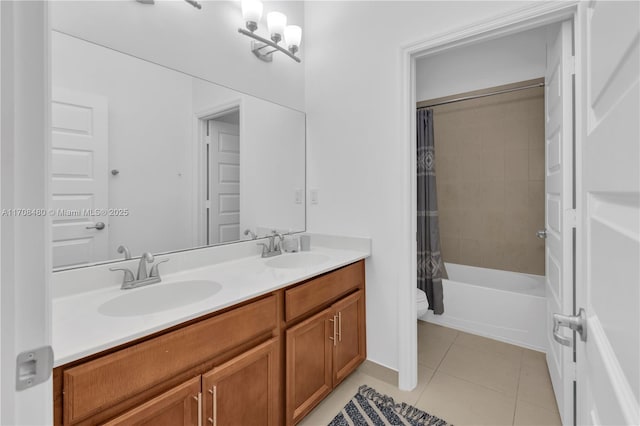 bathroom with double vanity, a sink, toilet, and tile patterned floors