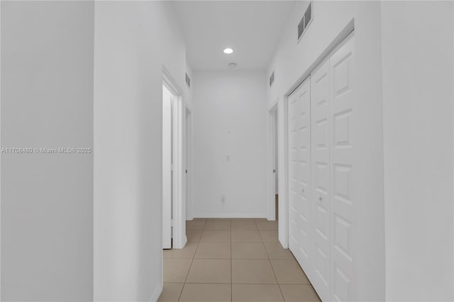 hall with recessed lighting, light tile patterned flooring, visible vents, and baseboards