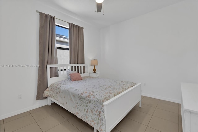 bedroom featuring ceiling fan, tile patterned flooring, and baseboards