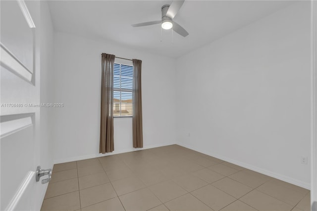 spare room featuring ceiling fan and baseboards