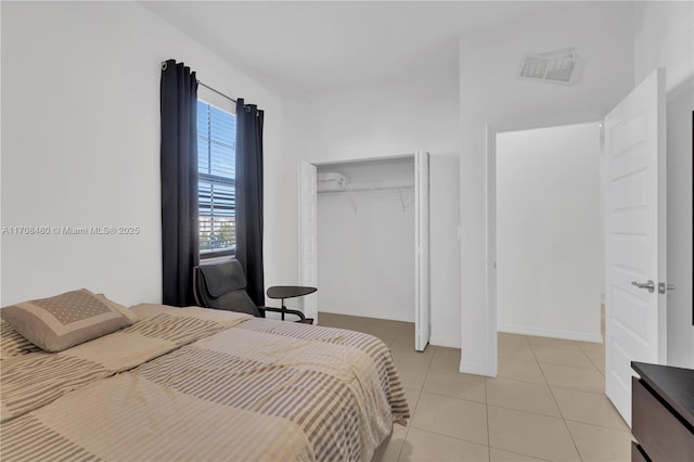 bedroom featuring a closet, visible vents, and light tile patterned floors