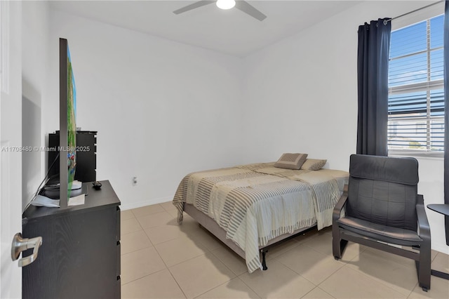 bedroom featuring ceiling fan, baseboards, and light tile patterned floors