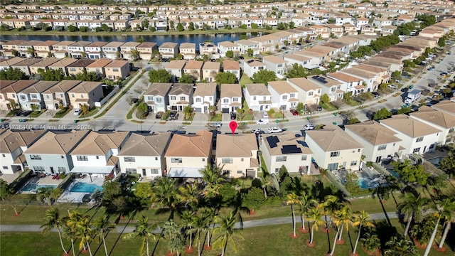 drone / aerial view featuring a residential view and a water view