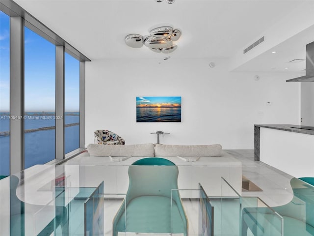 dining area featuring expansive windows and a water view