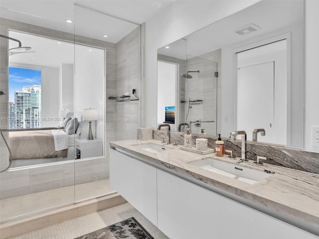 bathroom with tile patterned flooring, vanity, and an enclosed shower