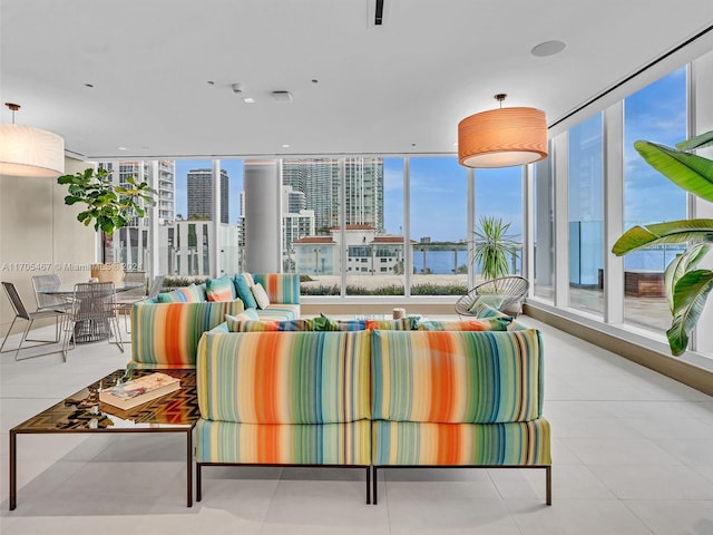 living room with expansive windows and light tile patterned floors