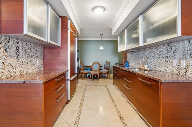 kitchen with pendant lighting, backsplash, sink, light stone countertops, and light tile patterned flooring