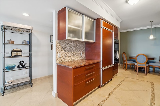 kitchen featuring tasteful backsplash, crown molding, pendant lighting, stone countertops, and light tile patterned floors