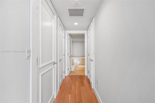 corridor featuring light hardwood / wood-style floors