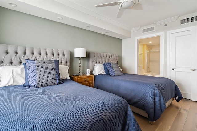 bedroom featuring ensuite bath, ceiling fan, light hardwood / wood-style flooring, and ornamental molding