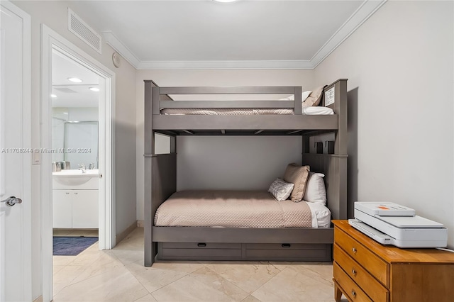 bedroom with ensuite bath, crown molding, and sink