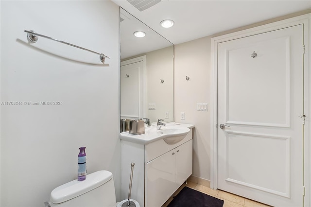 bathroom with tile patterned flooring, vanity, and toilet