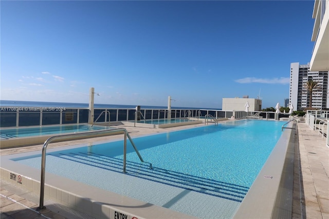 view of swimming pool featuring a water view