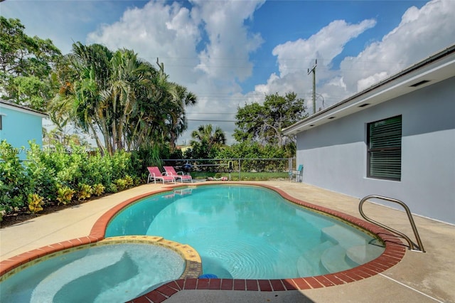 view of swimming pool with a patio area and an in ground hot tub