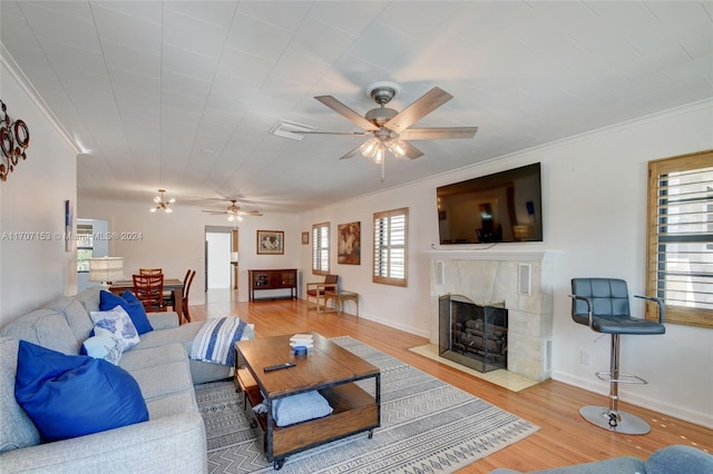 living room with hardwood / wood-style flooring, plenty of natural light, ceiling fan, and ornamental molding