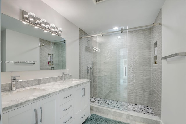 bathroom with vanity and a shower with shower door