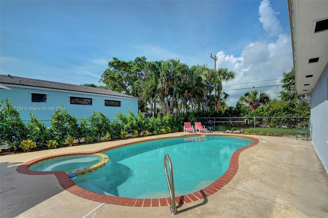 view of swimming pool with an in ground hot tub and a patio