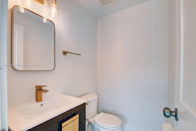 bathroom featuring vanity and toilet