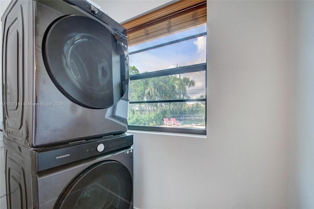 laundry area featuring stacked washer / drying machine