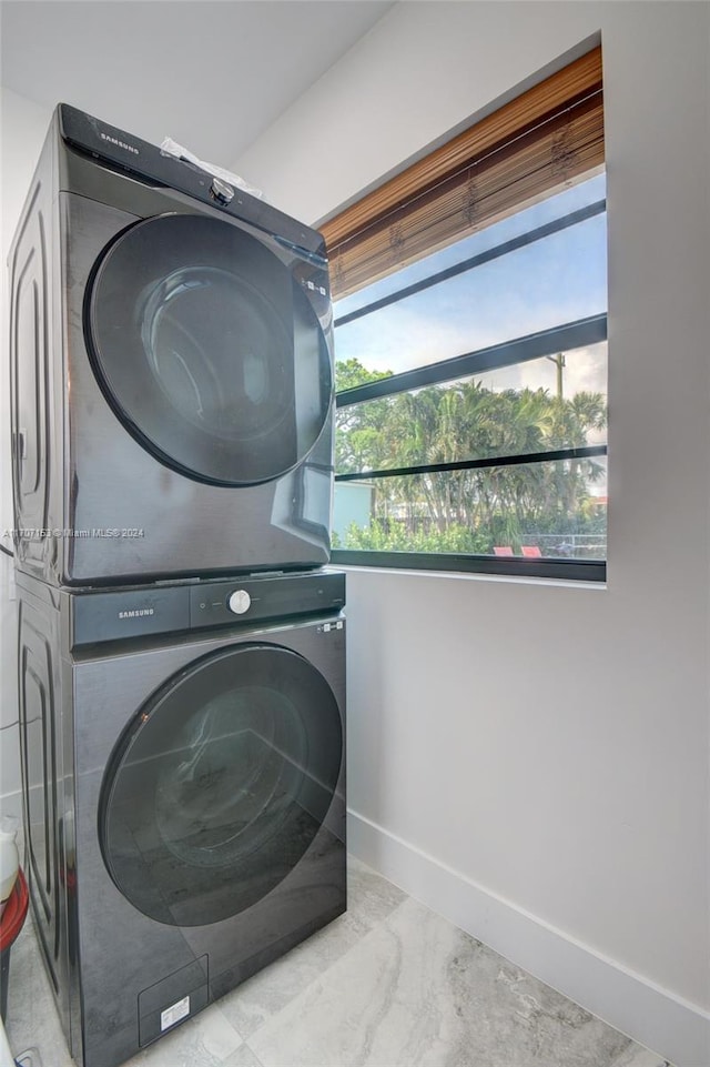 laundry area with stacked washer and clothes dryer