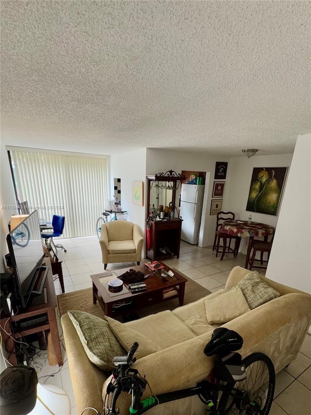 living room with light tile patterned floors and a textured ceiling