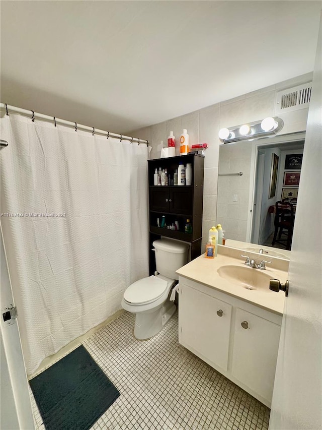 bathroom featuring vanity, toilet, and walk in shower