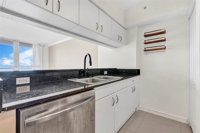 kitchen with white cabinetry, dishwasher, light tile patterned floors, and sink