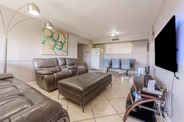 tiled living room with a textured ceiling