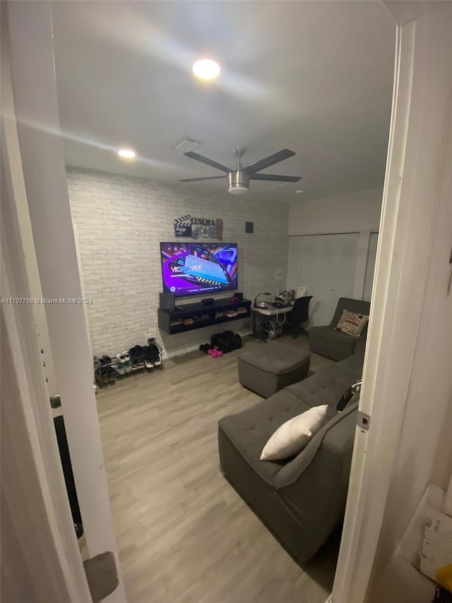 living room featuring ceiling fan and wood-type flooring