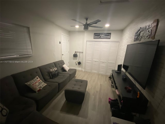 living room featuring light hardwood / wood-style floors and ceiling fan