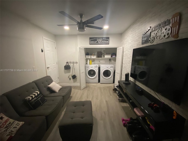 living room with washing machine and dryer, ceiling fan, and light hardwood / wood-style flooring