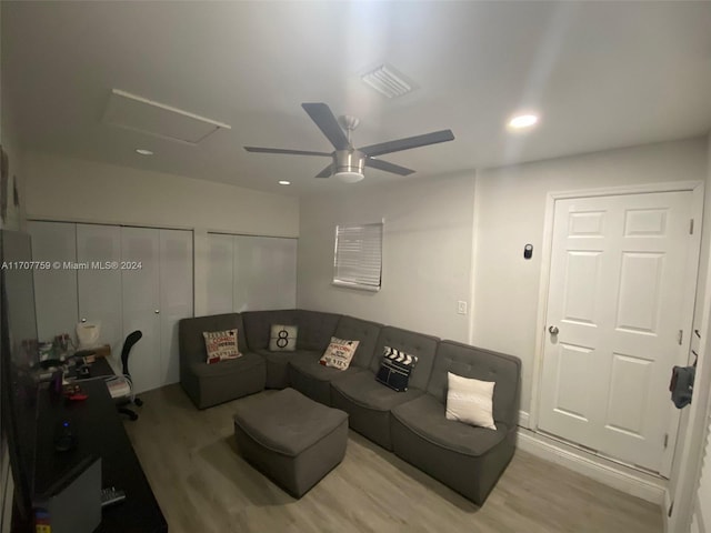 living room with ceiling fan and light hardwood / wood-style flooring