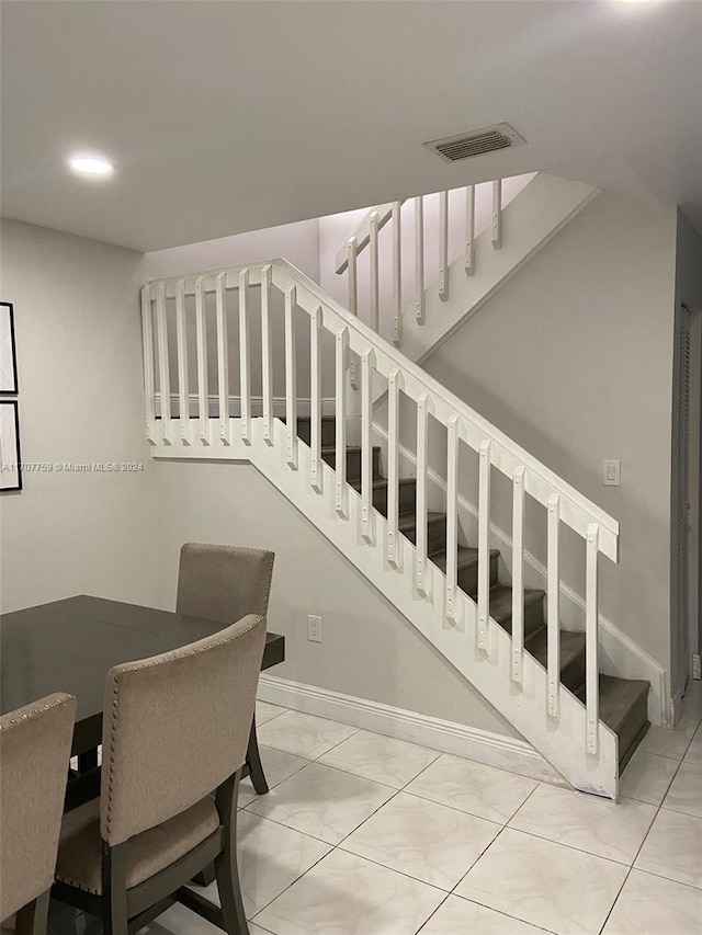 staircase featuring tile patterned floors